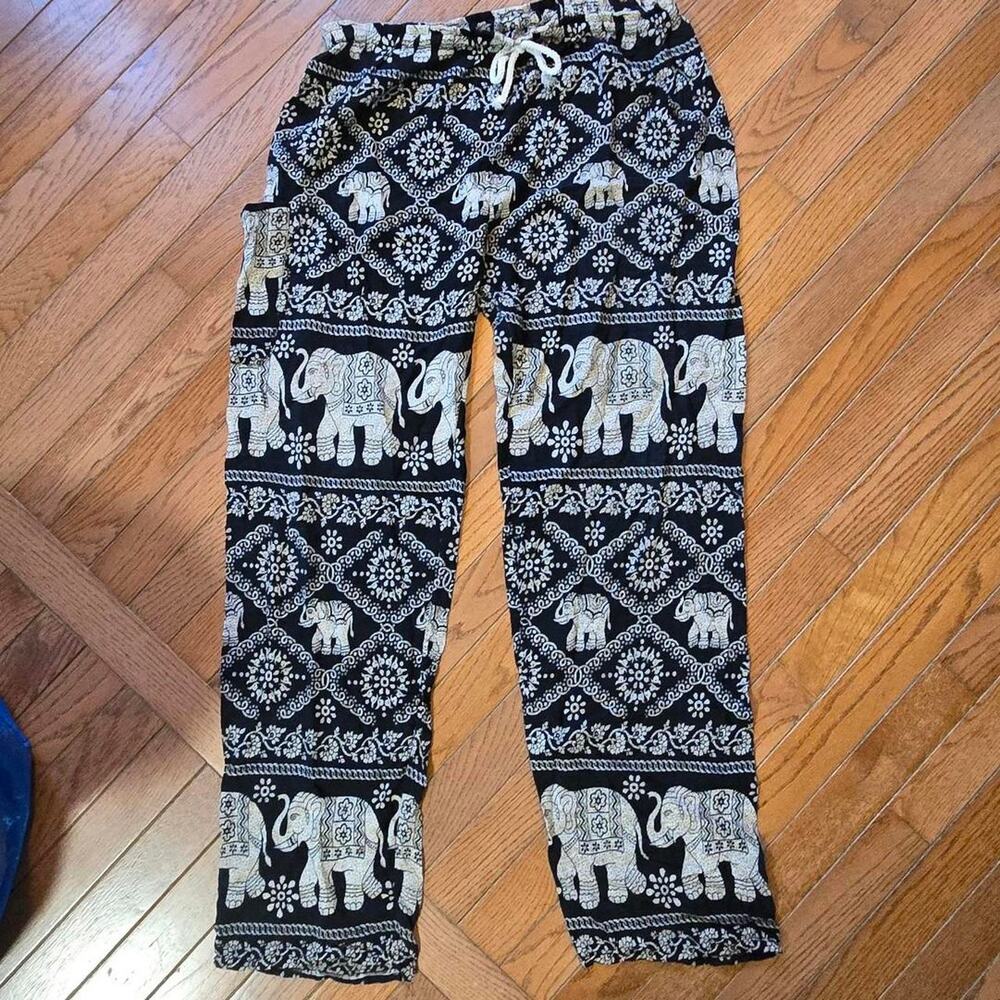 Black and white elephant print pants with geometric patterns, size M
